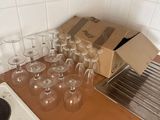 a box of empty wine glasses sitting on a kitchen counter