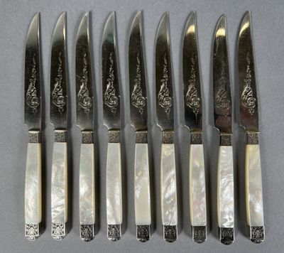 six knives are lined up next to each other on a table