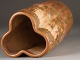 a brown vase with a flower inside of it