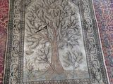 a rug on the floor with a bird on it