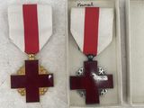 three medals and a ribbon in a box on a table