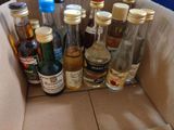 many bottles of alcohol in a box on the floor