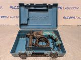 an electric drill in a blue case on a white surface