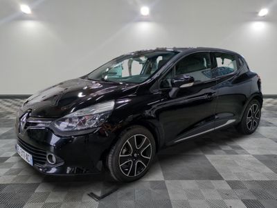 a black car is parked in a room with a checkered floor