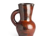 a brown vase with a handle on a white background