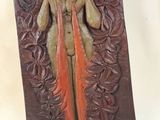 statue of a woman with a long hair and a long tail on a wooden base