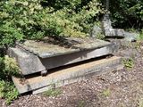 a stone bench sitting in the middle of the woods