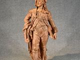 statue of a man in a military uniform holding a rifle