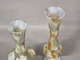 two vases sitting next to each other on a table