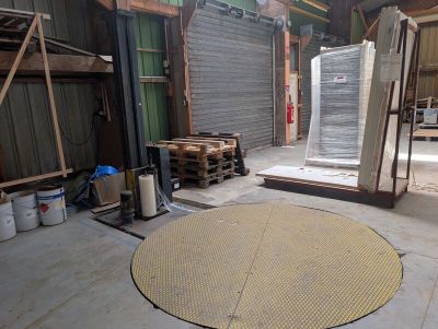 a picture of a warehouse with a lot of boxes and pallets