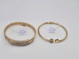 two gold bracelets with diamonds on them