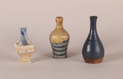 three vases sitting next to each other on a table