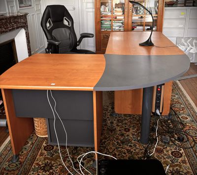 a desk with a chair and a lamp on it