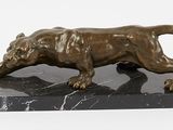 statue of a lion on a marble base on a white background