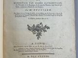 un livre ouvert sur lequel est posée une image représentant une fleur