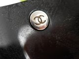 chanel logo on the side of a black leather purse