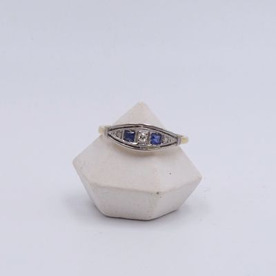 an image of a diamond and sapphire ring on a white background