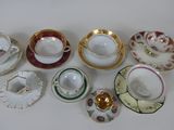 a lot of tea cups and saucers sitting on a table