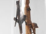a glass jar with a wooden structure inside of it