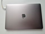 a silver laptop with an apple logo on the screen