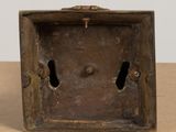 an old wooden box with two holes in it on a table
