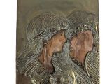 a picture of a metal plaque with a woman and a child