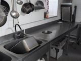 pots and pans hanging from the ceiling in a commercial kitchen