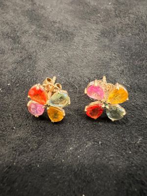 pair of multicolored flower earrings on a black surface