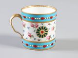 a cup with a floral design on it on a table