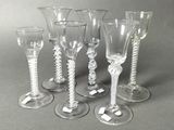 five wine glasses sitting next to each other on a table
