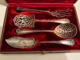 four spoons and a fork in a red box