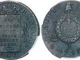 a close up of a coin with a bird on top of it