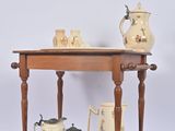 a wooden table with a shelf with vases on top of it