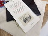 a black wallet with a price tag on it sitting on a table