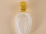 an image of a bottle of perfume on a white surface