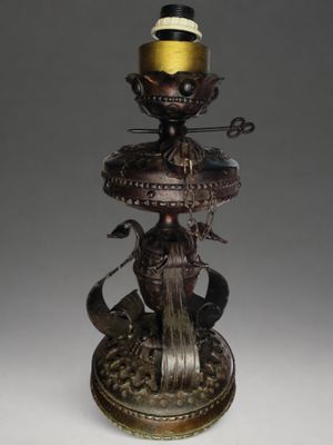 bronze statue of a bird on top of a fountain with a hat on it ' s head