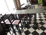 tables and chairs in a restaurant with checkered floor and black and white tile