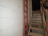 a ladder that is leaning against a wall next to a staircase
