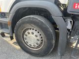 a truck with a flat tire parked on the side of the road