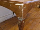 a wooden table with a wooden top on a hard wood floor