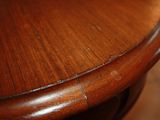 a close up of a wooden table with a wooden top