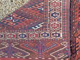 an image of a red and blue rug laying on top of a stone floor
