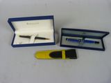 two pens and a tie bar in a blue box