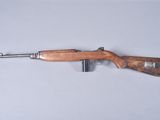 a close up of a wooden rifle on a white surface