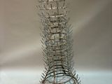 a tall glass vase that has a lot of spikes on it
