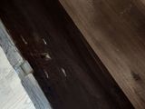 a toilet that is in a bathroom with a wooden floor