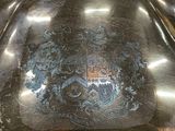 a silver plate with a coat of arms on it