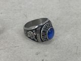 a close up of a ring with a blue stone on it