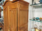 a large wooden cabinet with a clock on top of it