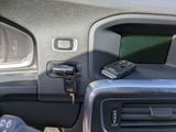 a cell phone sitting on the dashboard of a car